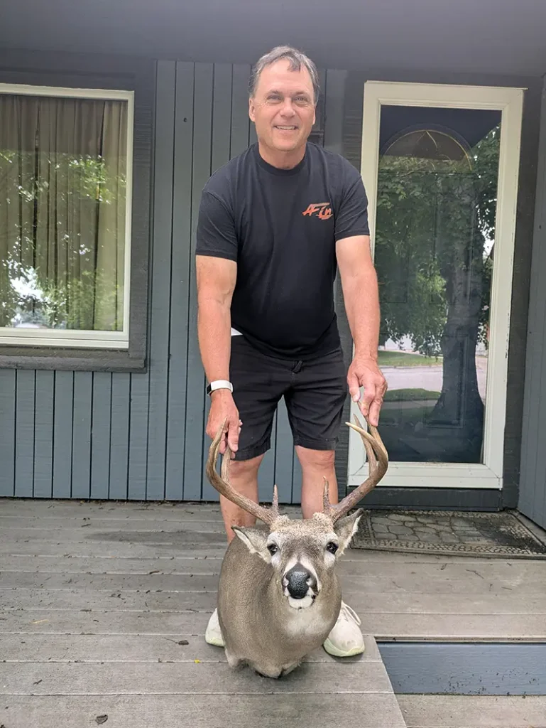person holding deer head mount
