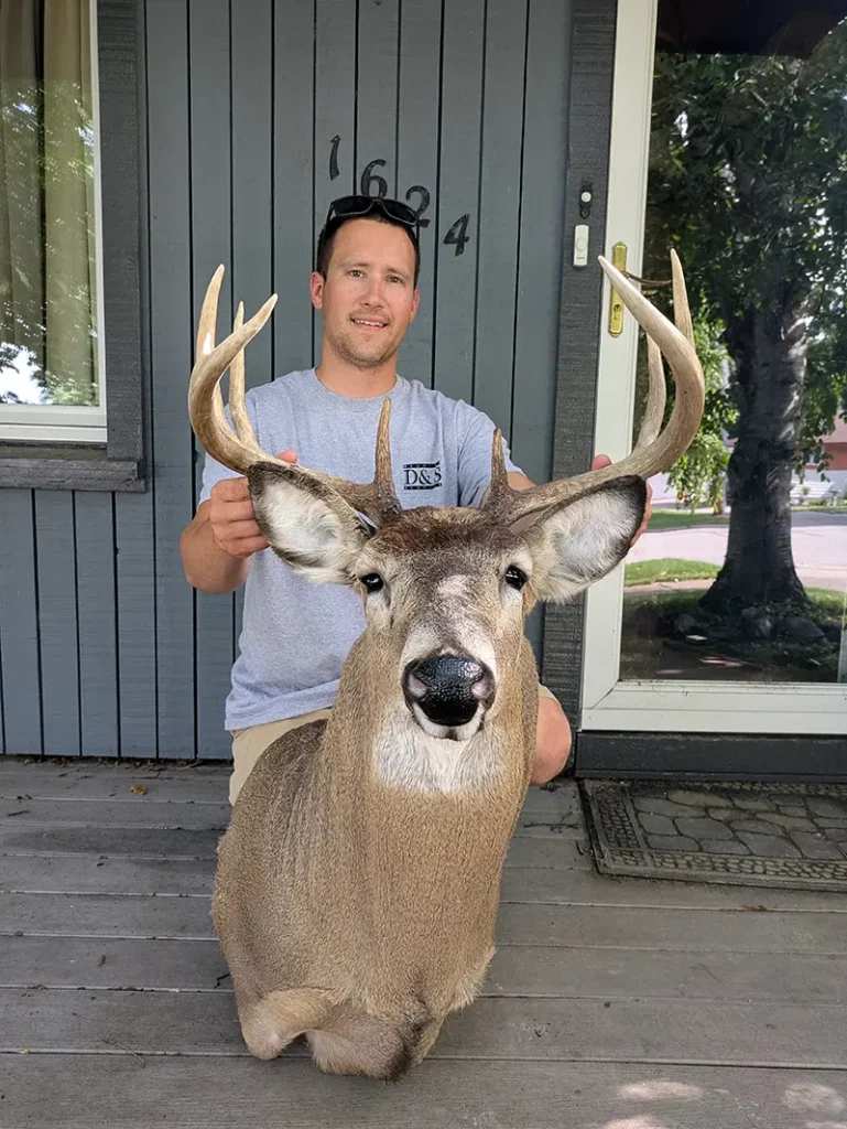 man holding deer head