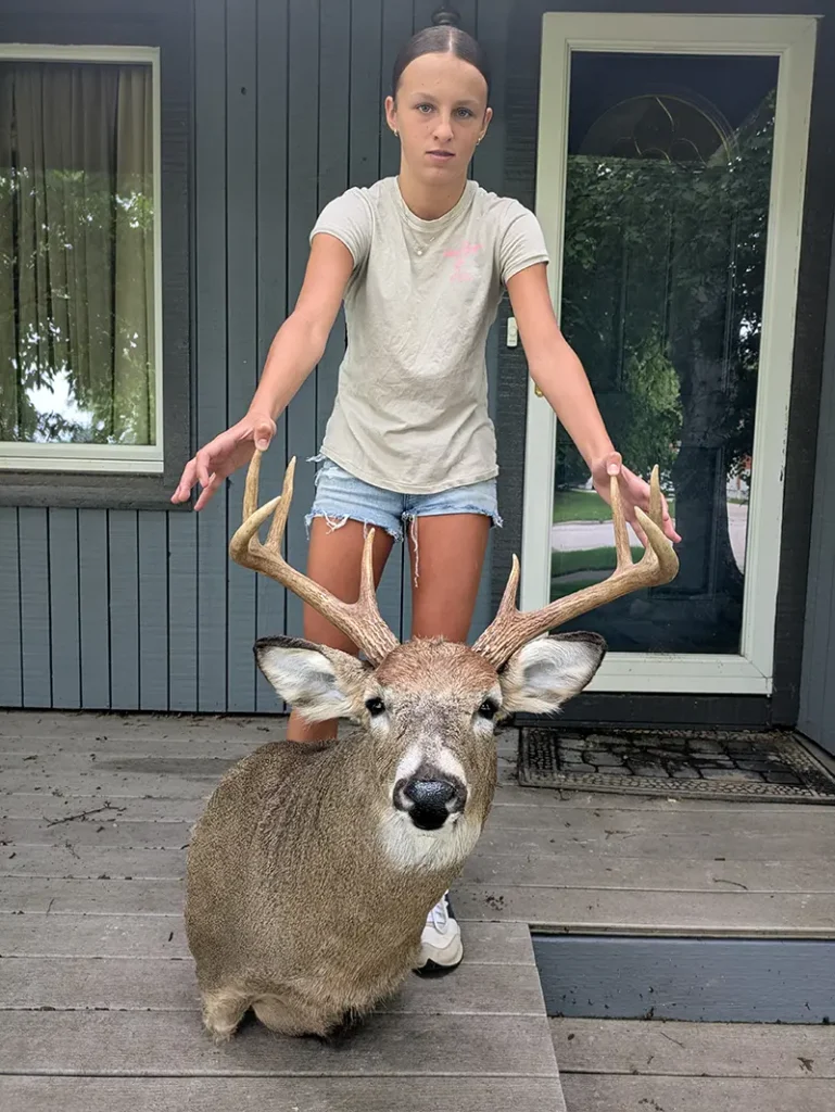 girl holding deer head