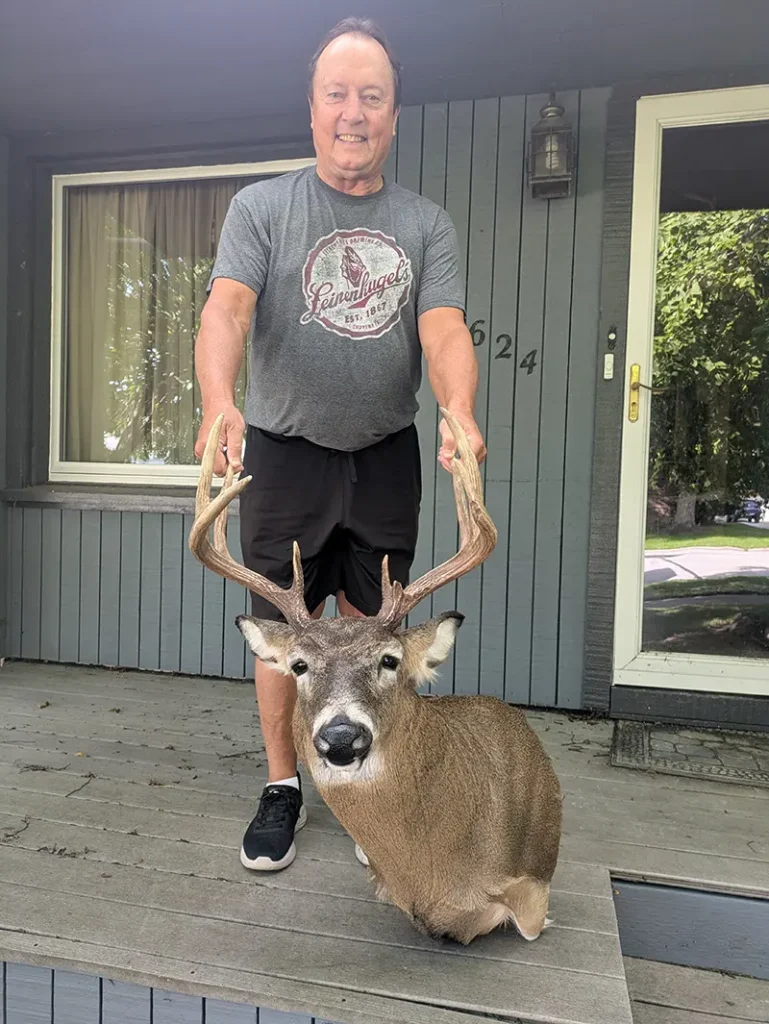 man smiling with deer head